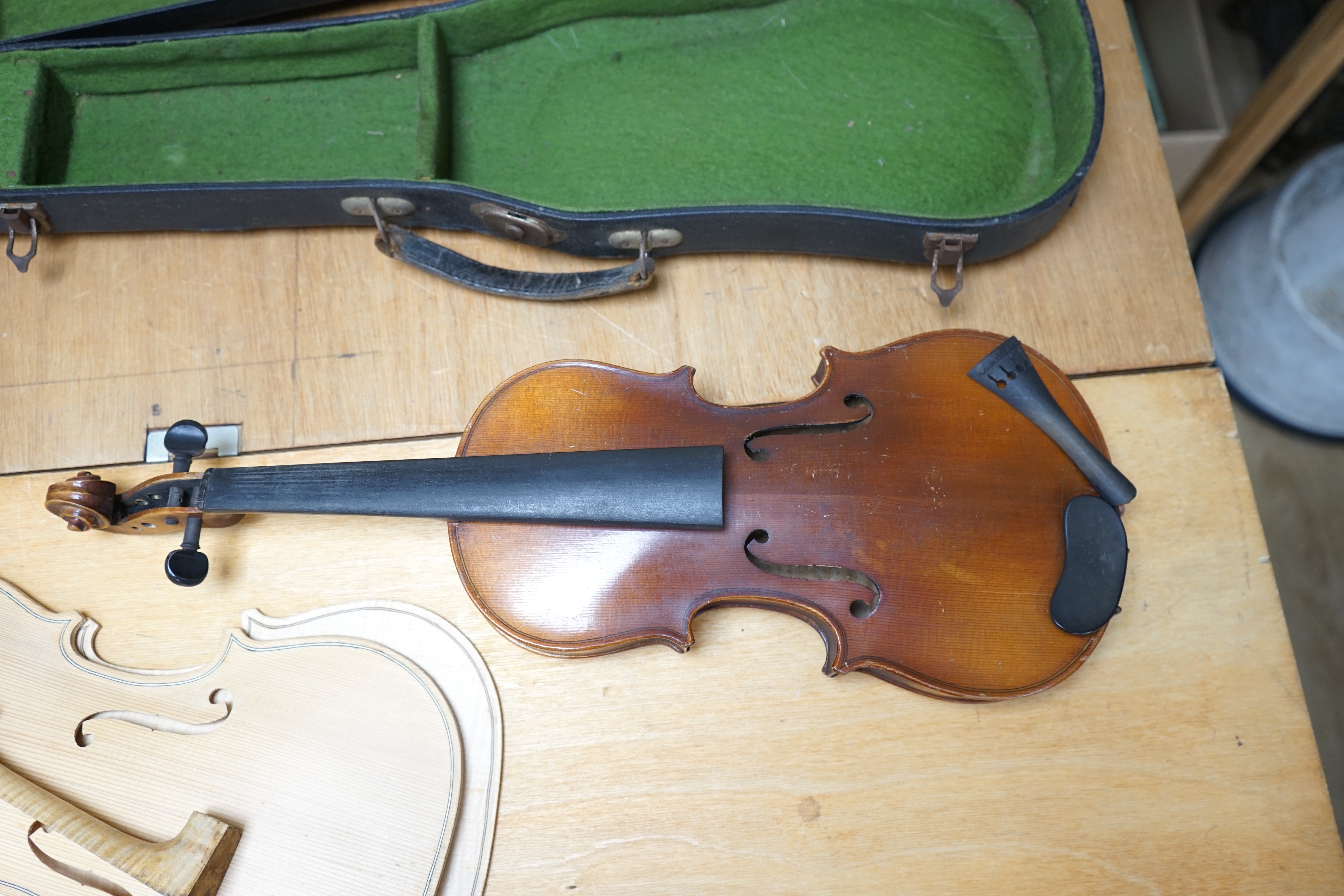 Early 20th century ¾ size violin, unlabelled, cased, together with a violin table, back and scroll. Condition - fair